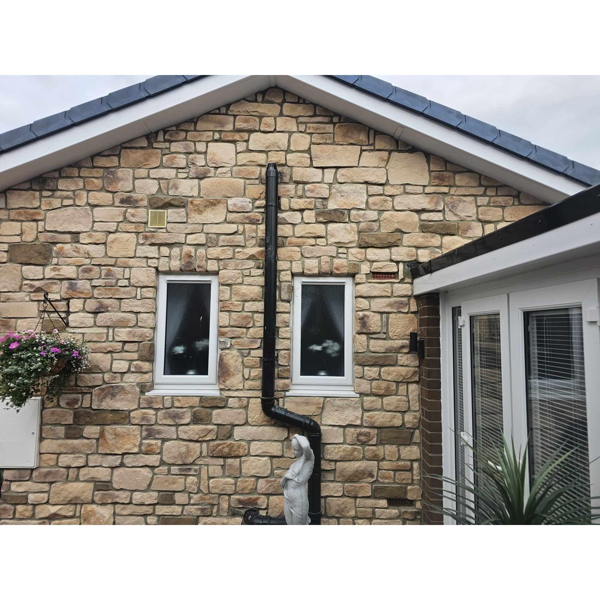 Sandstone Blend stone cladding on a residential home exterior with window details