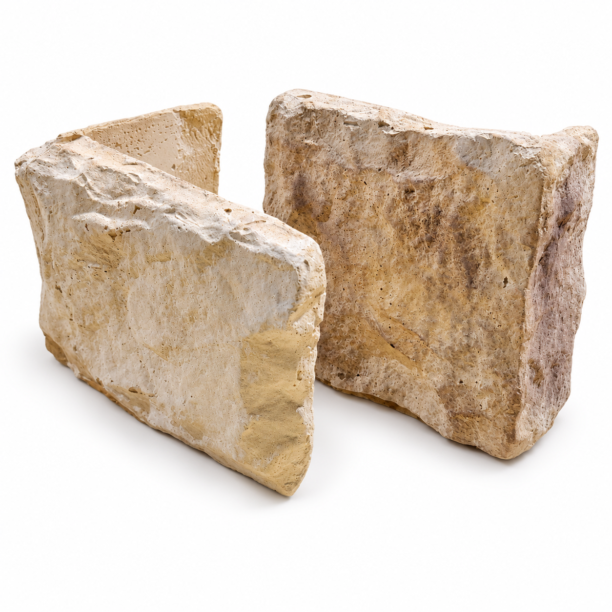 Two Cotswold Blend stone cladding corners showing their textured cream and beige faces and corner returns on a white background