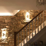 Elegant staircase featuring Cotswold Blend Stone Cladding, enhanced by warm lighting for a natural aesthetic.