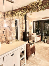 Cozy interior featuring stone cladding walls, a modern fireplace, and stylish lighting accents in a warm living space.