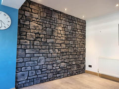 Stone cladding in midnight grey showcased on an interior wall, enhancing the room's natural aesthetics and design.
