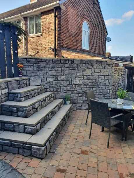 Stone cladding wall and steps in a stylish patio setting, showcasing the beauty of stone slips in outdoor design.