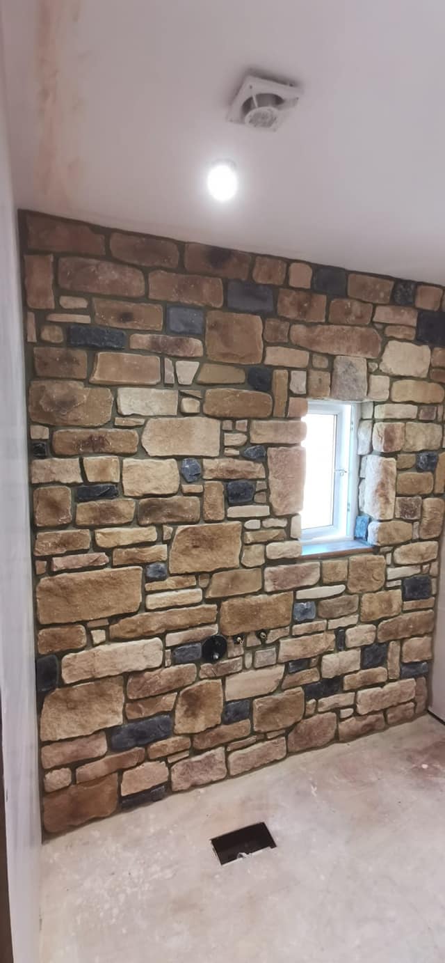 Antique Blend Stone Cladding installed on a wall, showcasing natural stone aesthetics with window and modern design elements.