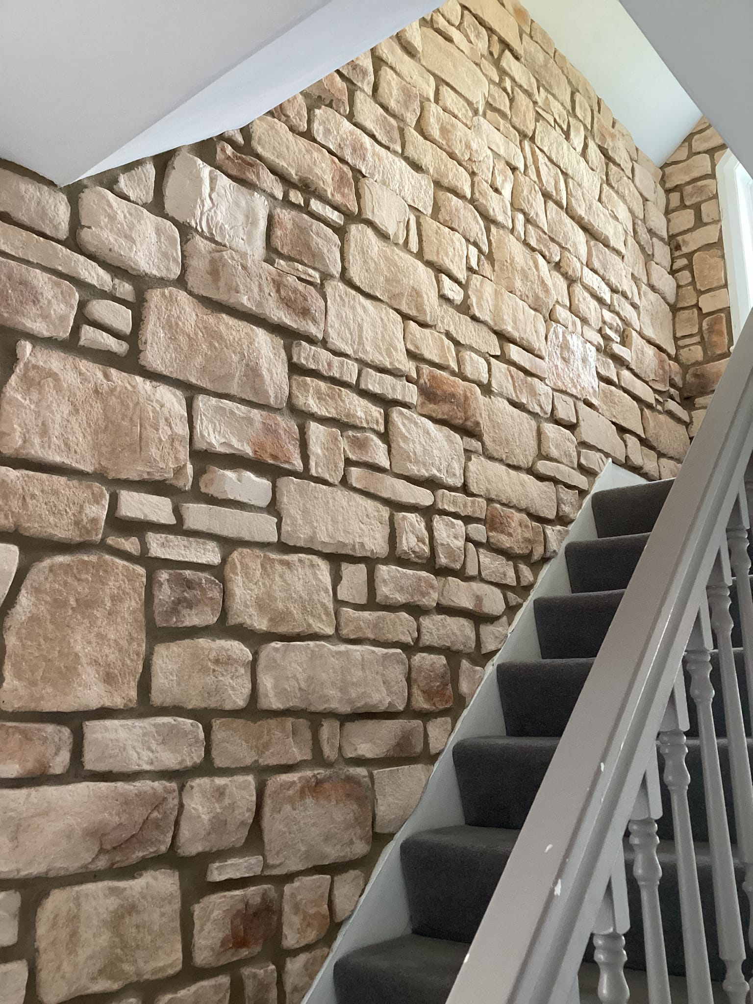 Stone cladding wall in a staircase corridor, showcasing the Burnt Buff Blend design and natural stone aesthetics.