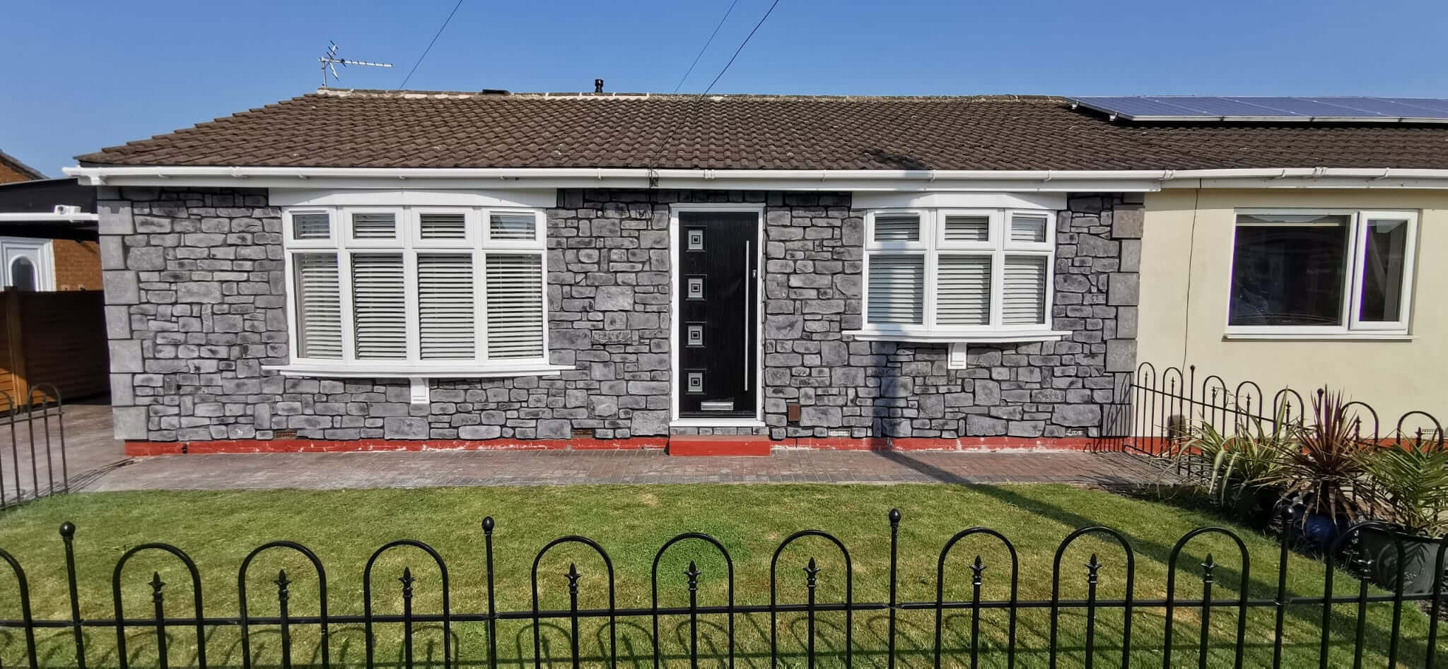 Stone cladding in midnight grey enhances a home's exterior with modern aesthetics and natural stone appeal.