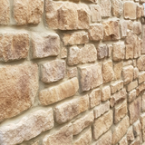 Stone cladding feature wall in Cotswold Blend, showcasing textured stone slips for a natural aesthetic.