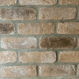 Rustic cream blend brick slips featuring a mixture of buff and weathered finishes on a textured surface.